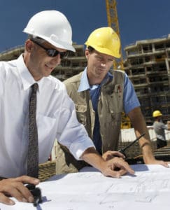  general-contractors-viewing-blueprint-at-construction-site