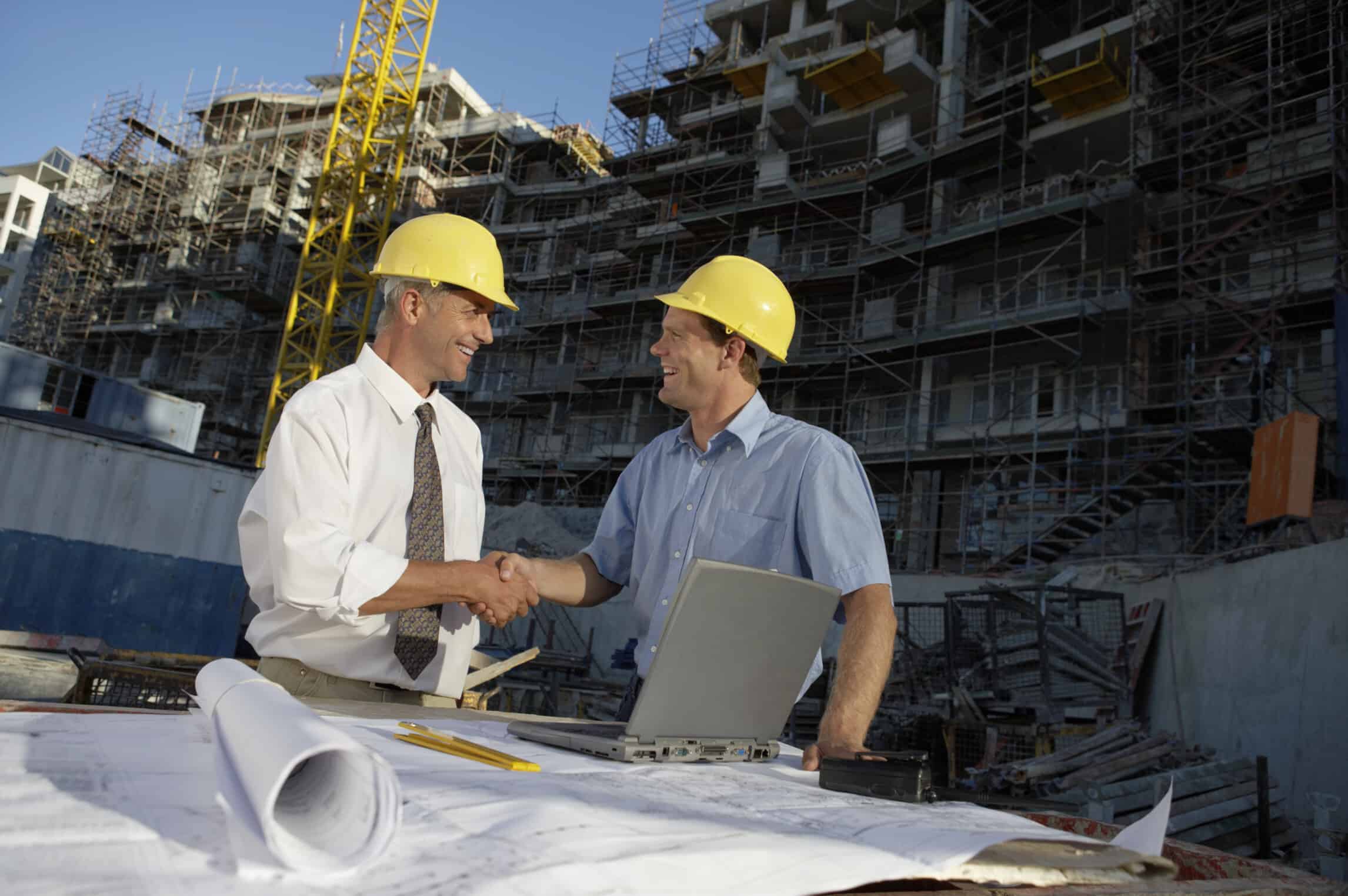 men-shaking-hands-in-hard-hats-on-construction-site